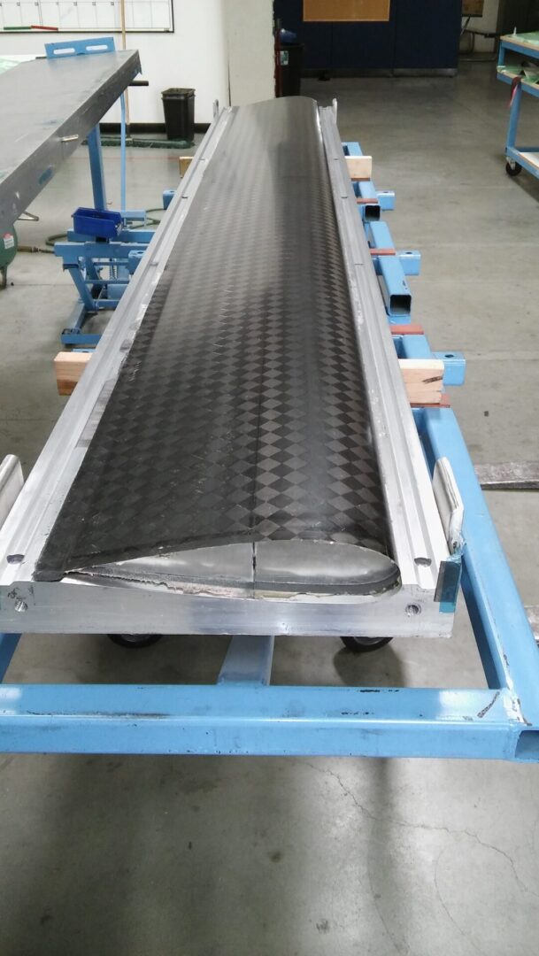 A conveyor belt with metal strips on it.